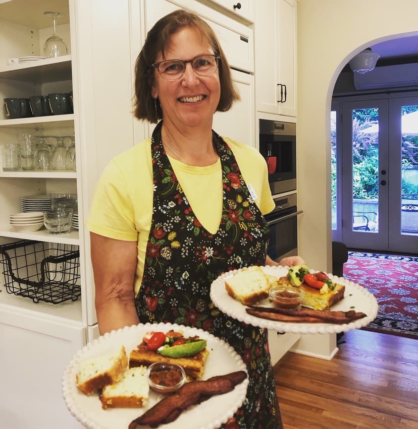 woman holding plates with breakfast