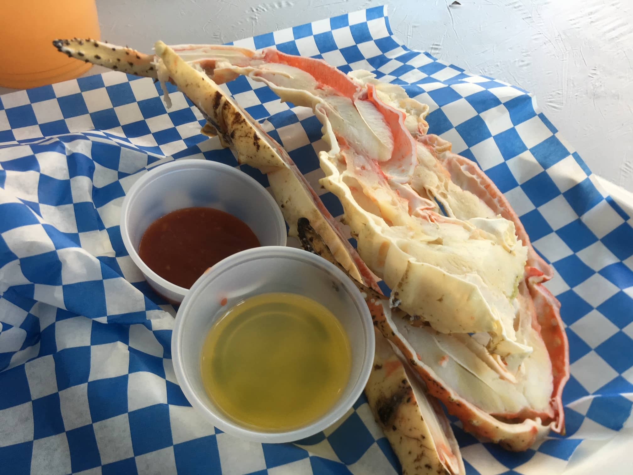 Cooked half lobster in shell with butter and cocktail sauce