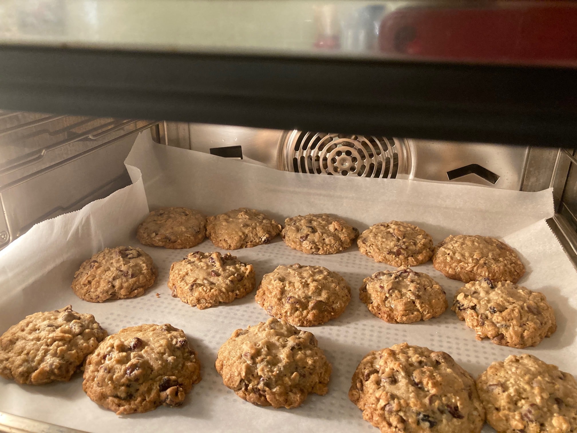 oatmeal cookies baking in oven on parchment paper